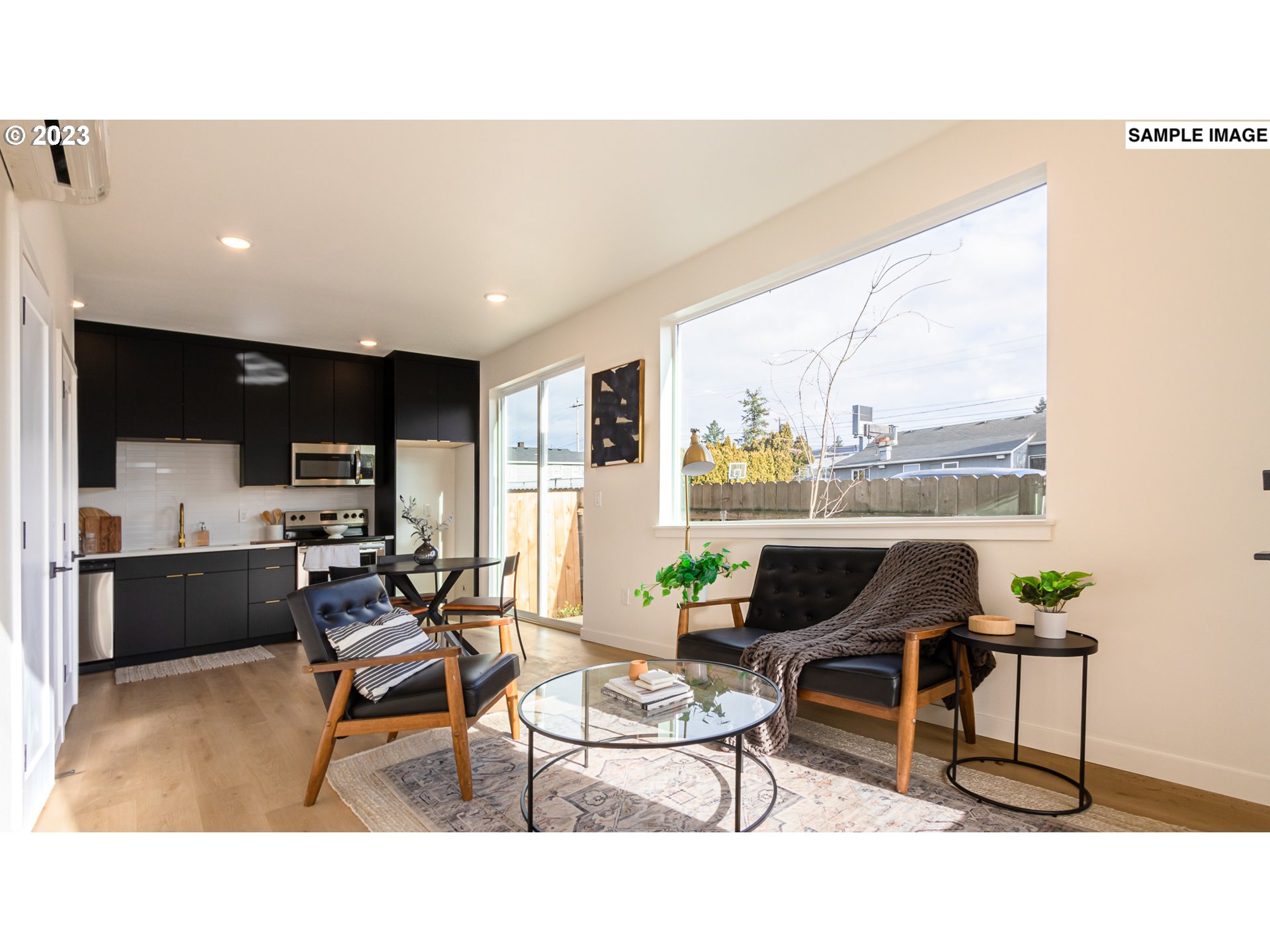12063 Southeast Oak Street Portland, OR 97216 - Photo 2 of 11 a living room with furniture a flat screen tv and a table