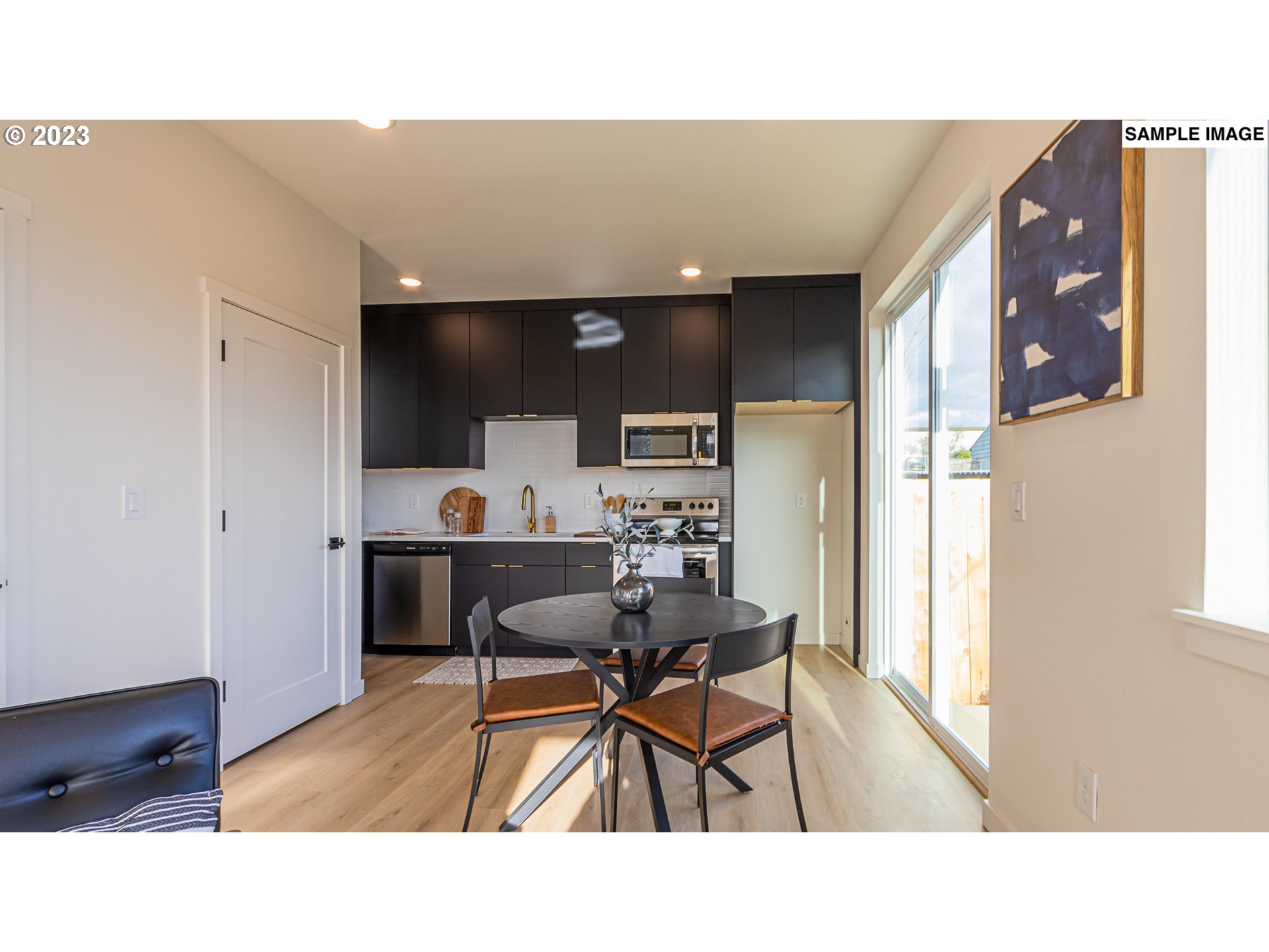 12063 Southeast Oak Street Portland, OR 97216 - Photo 5 of 11 a kitchen with a dining table and chairs