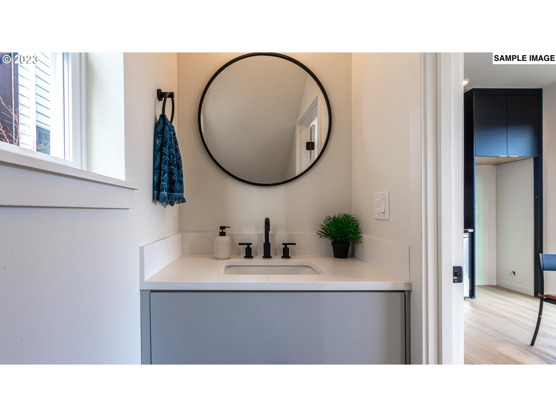 12063 Southeast Oak Street Portland, OR 97216 - Photo 6 of 11 a bathroom with a sink vanity and a mirror