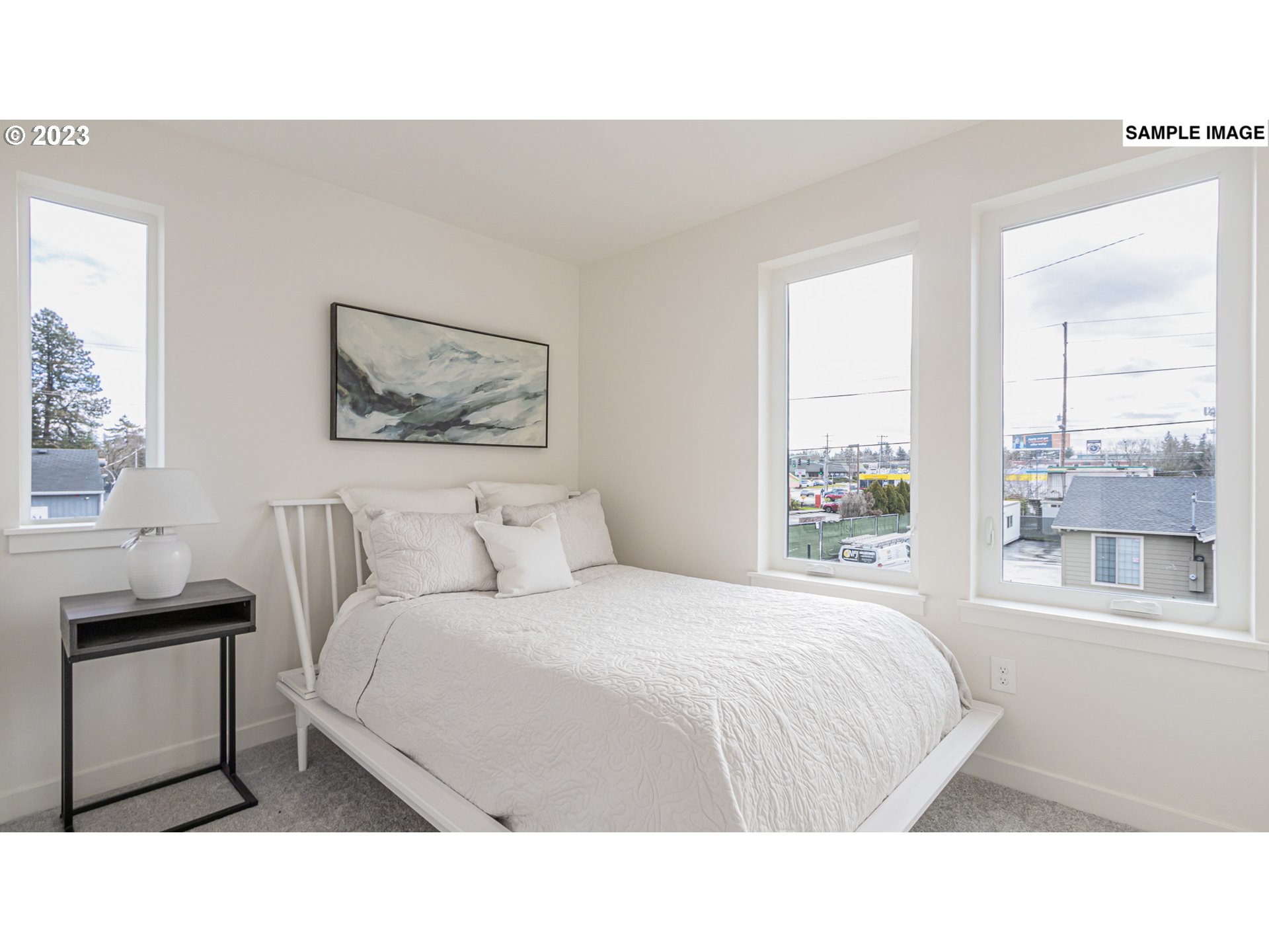 12063 Southeast Oak Street Portland, OR 97216 - Photo 7 of 11 a bedroom with a bed and a window