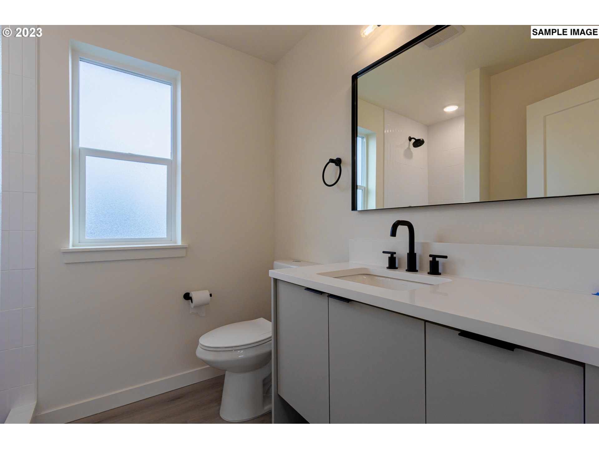 12063 Southeast Oak Street Portland, OR 97216 - Photo 8 of 11 a bathroom with a granite countertop sink a toilet and a mirror