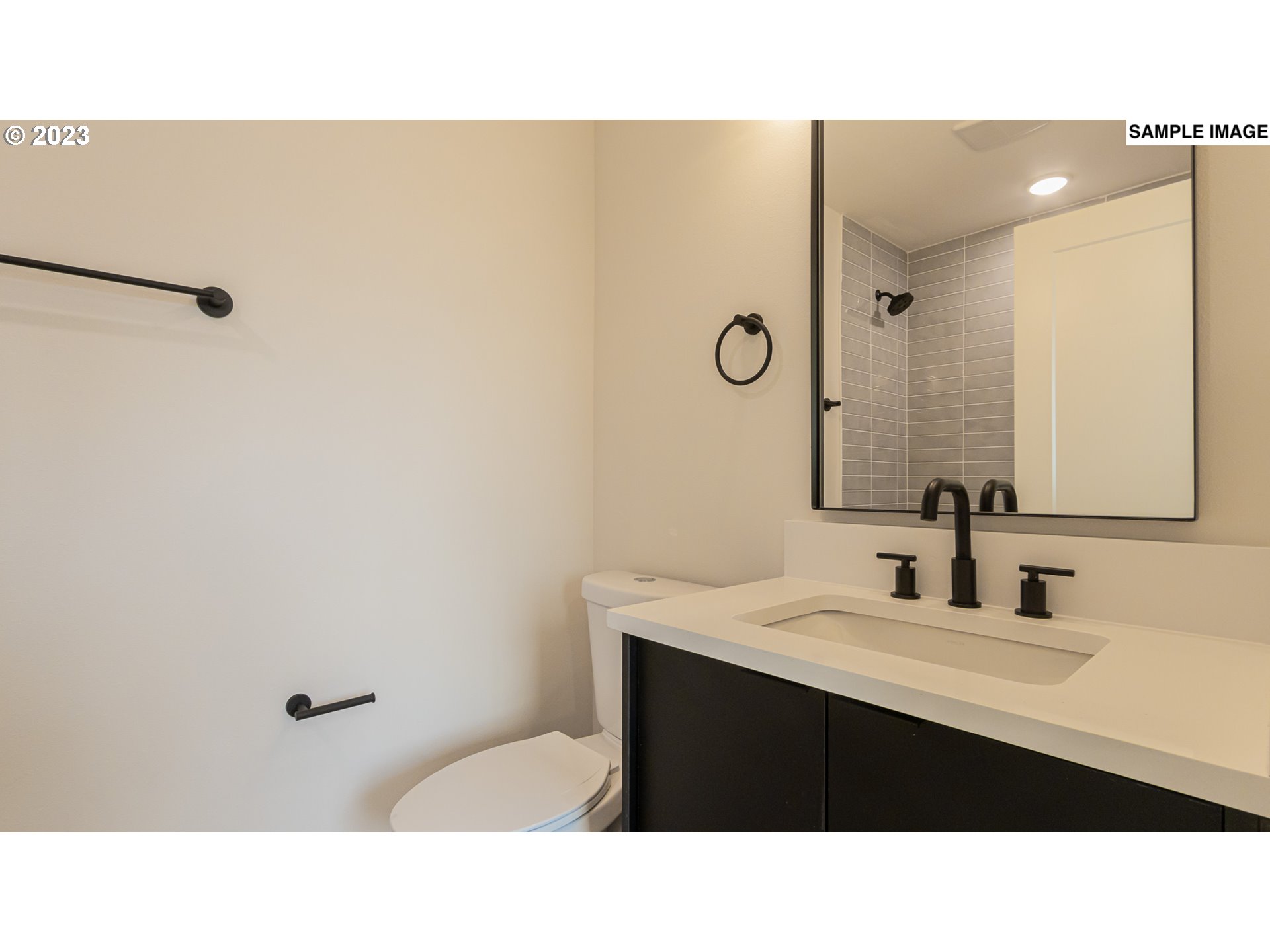 12063 Southeast Oak Street Portland, OR 97216 - Photo 10 of 11 a bathroom with a sink a mirror and a toilet