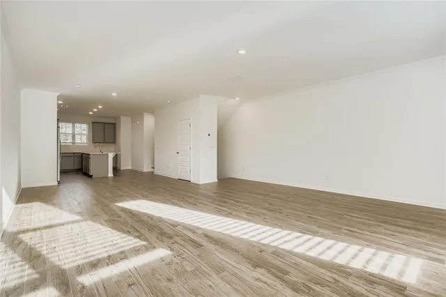 a view of kitchen and hall with wooden floor