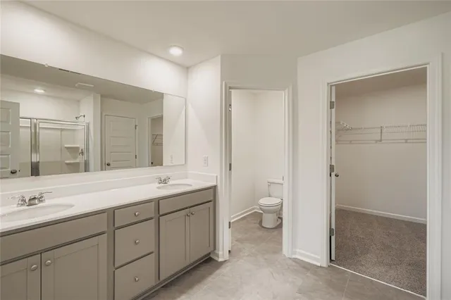 a spacious bathroom with a granite countertop sink mirror and toilet