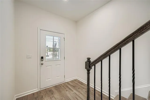 a view of an entryway with wooden floor