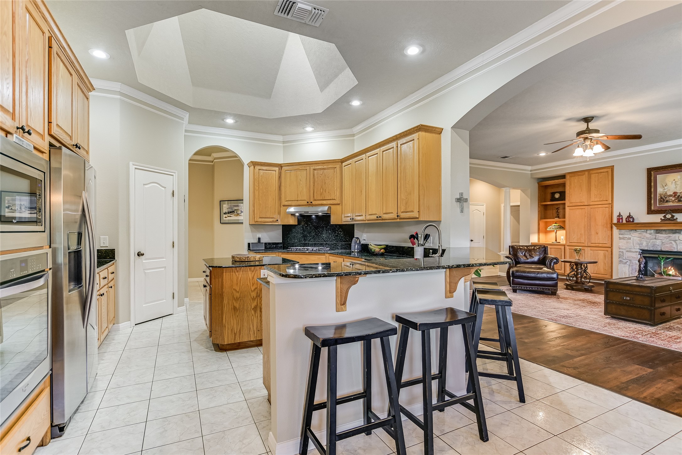 741 Knobbs Road McDade, TX 78650 - Photo 10 of 38 A well-appointed kitchen featuring granite counters and stainless steel appliances flows seamlessly into the inviting living area.
