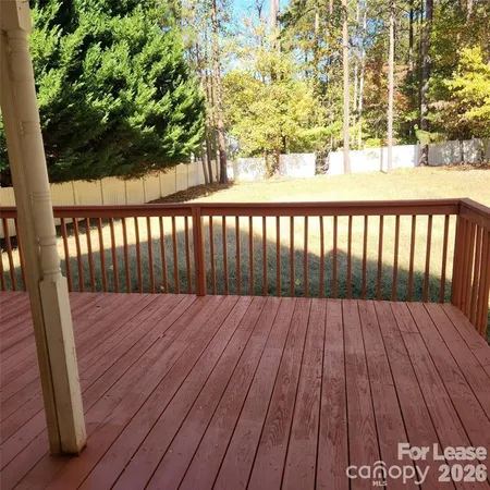 a view of swimming pool with wooden fence