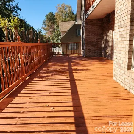 a view of deck with wooden floor and fence and a floor to ceiling window