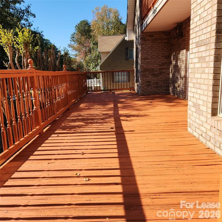 208 Chuckwood Road Mooresville, NC 28117 - Photo 2 of 15 a view of deck with wooden floor and fence and a floor to ceiling window