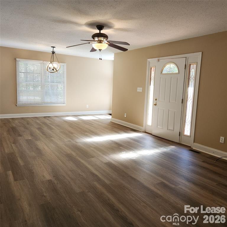 208 Chuckwood Road Mooresville, NC 28117 - Photo 3 of 15 a view of an empty room with a chandelier fan
