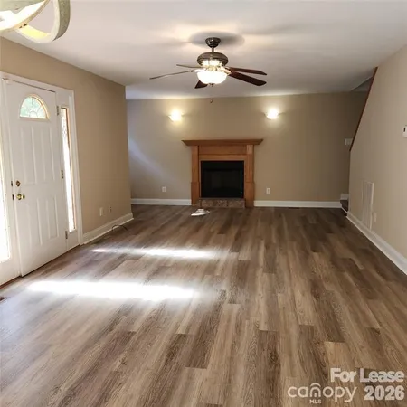 wooden floor in an empty room with a fireplace