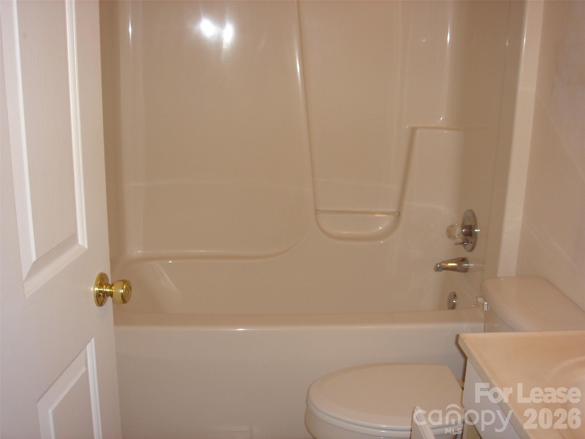 208 Chuckwood Road Mooresville, NC 28117 - Photo 8 of 15 a bathroom with a toilet and a bath tub