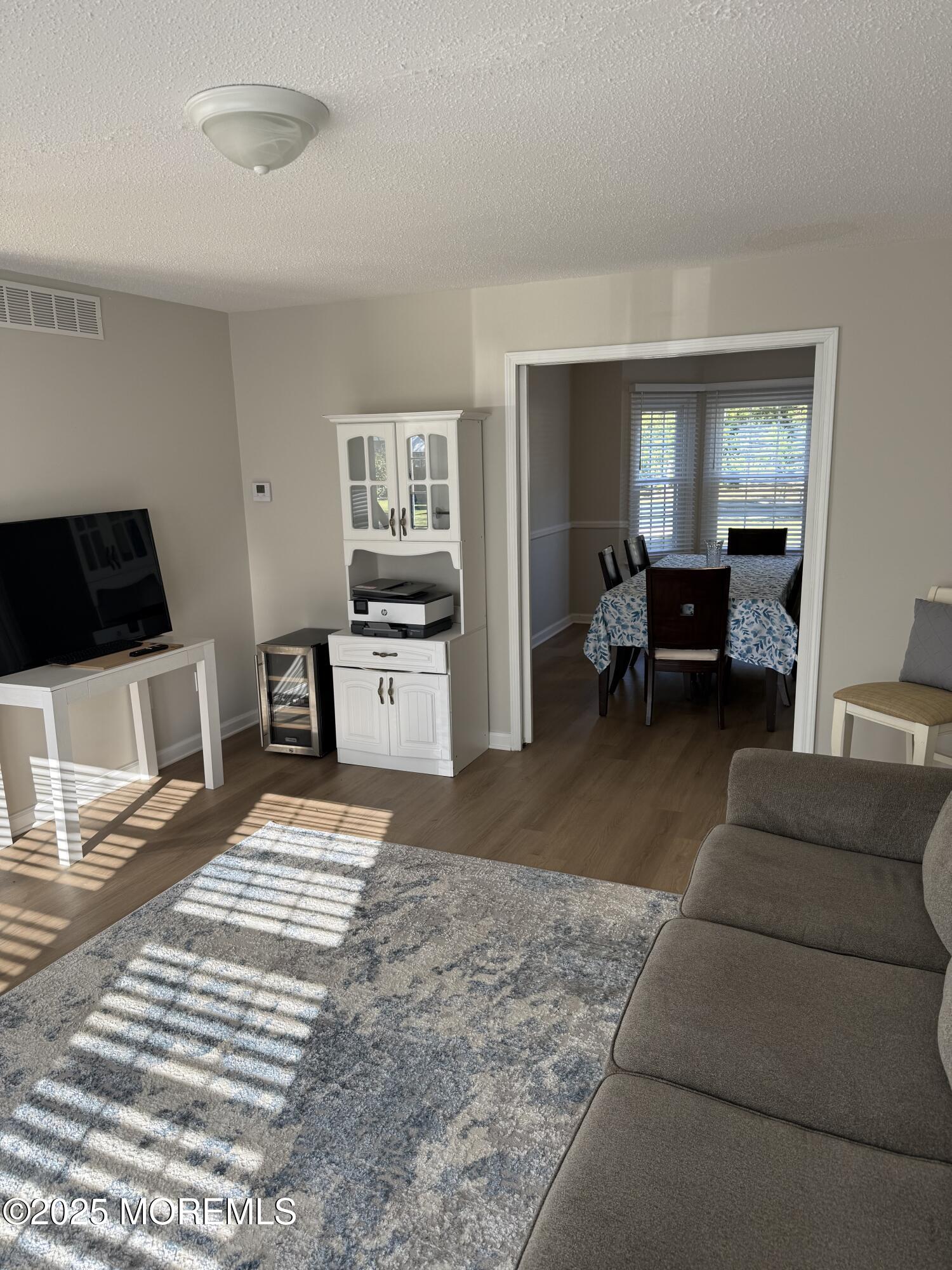 90 Atlantis Avenue Manahawkin, NJ 08050 - Photo 11 of 23 a living room with furniture and a table
