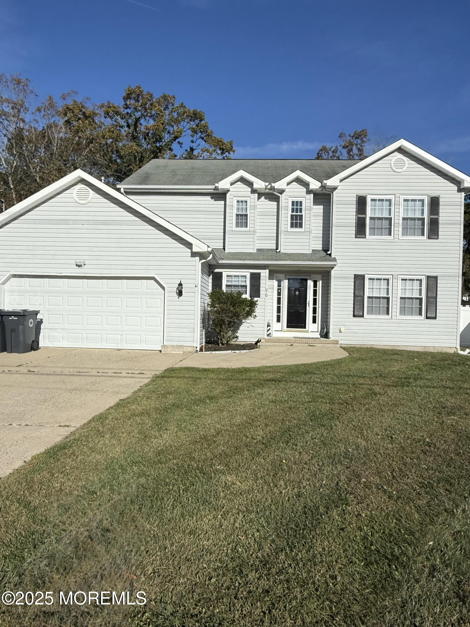 90 Atlantis Avenue Manahawkin, NJ 08050 - Photo 2 of 23 a view of a white house next to a yard with big trees