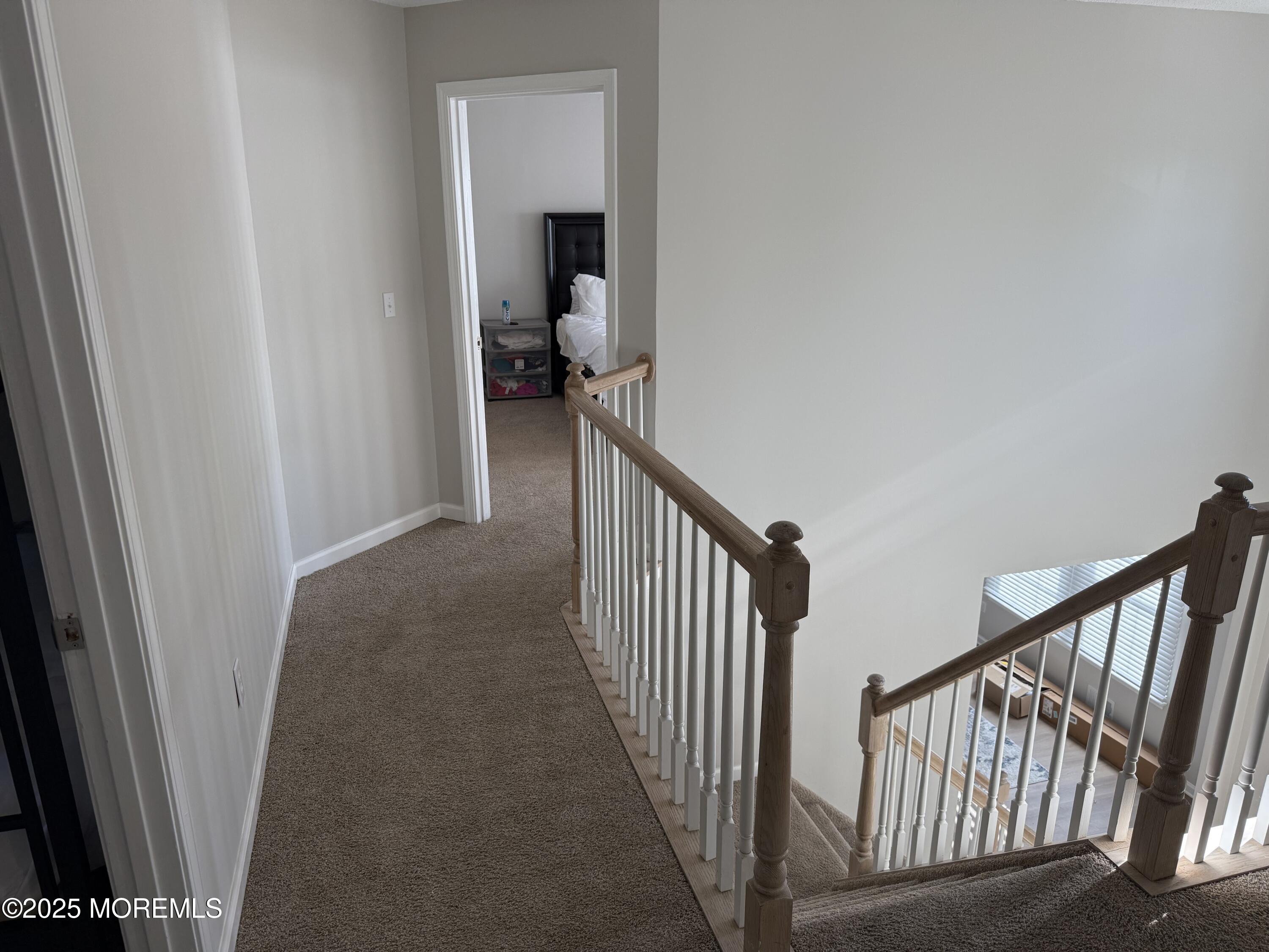90 Atlantis Avenue Manahawkin, NJ 08050 - Photo 23 of 23 a view of a hallway with wooden floor and a bathroom
