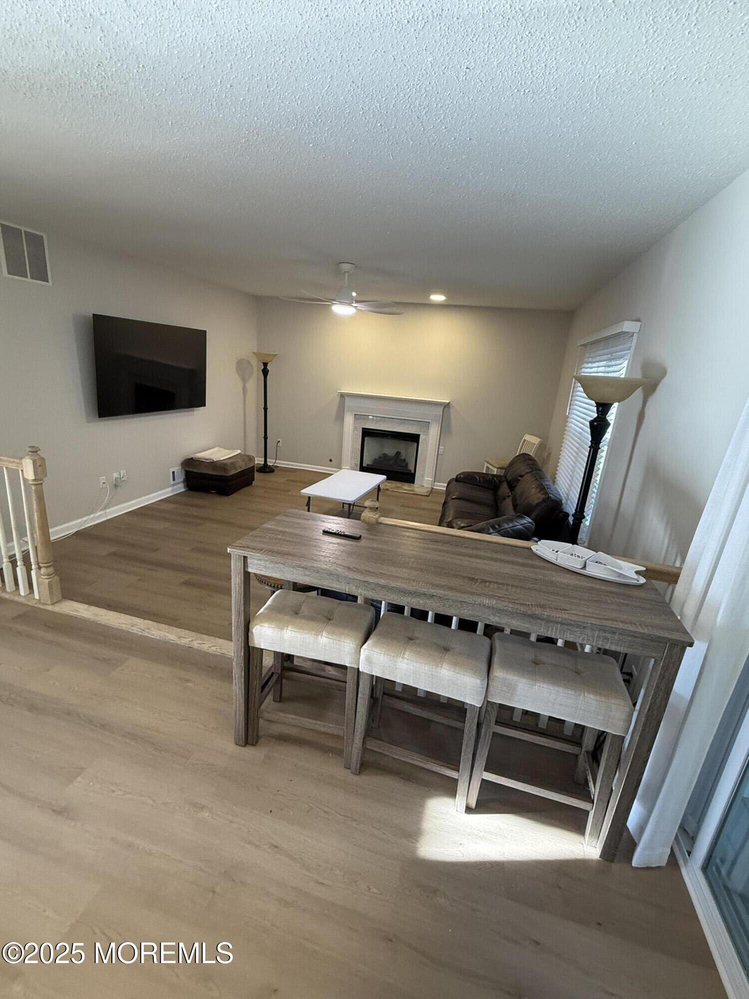 90 Atlantis Avenue Manahawkin, NJ 08050 - Photo 9 of 23 a living room with furniture and a flat screen tv