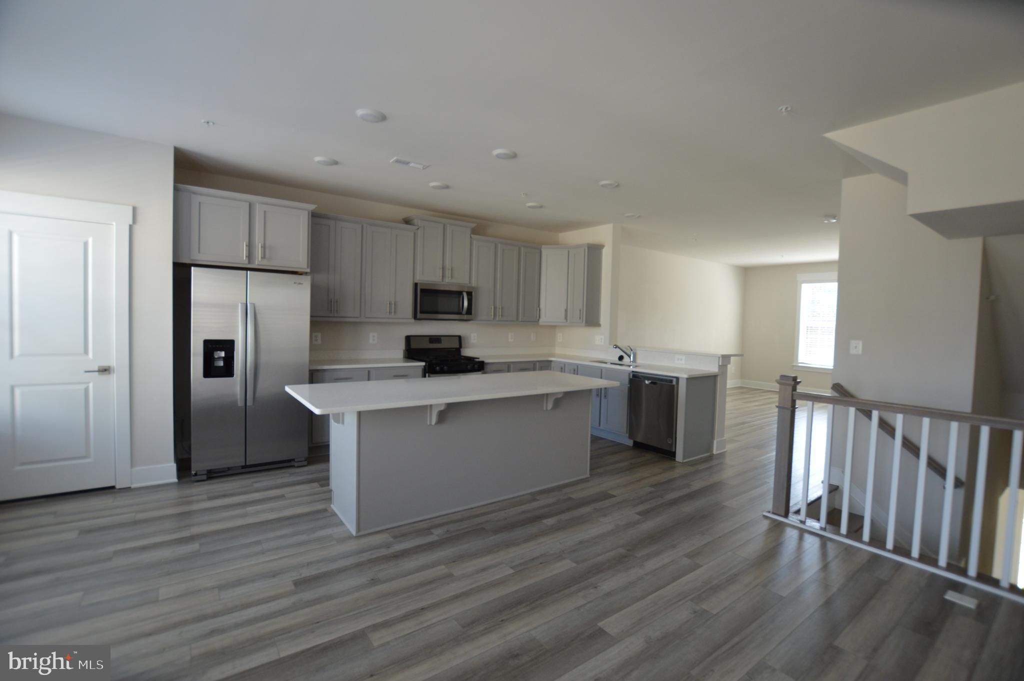 7927 Wormans Mill Road Frederick, MD 21701 - Photo 5 of 17 a kitchen with stainless steel appliances a refrigerator sink and cabinets