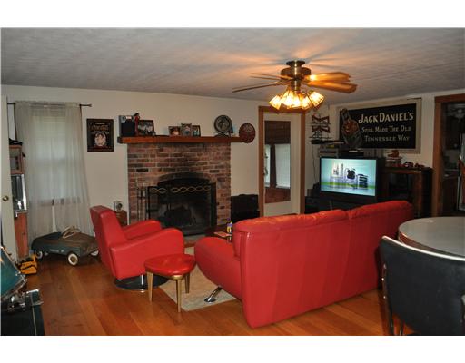 12 Burgess Road Foster, RI 02825 - Photo 4 of 13 Den/Family/Great Room. Great room featuring hardwood floors, a dry bar and a wood burning fireplace.