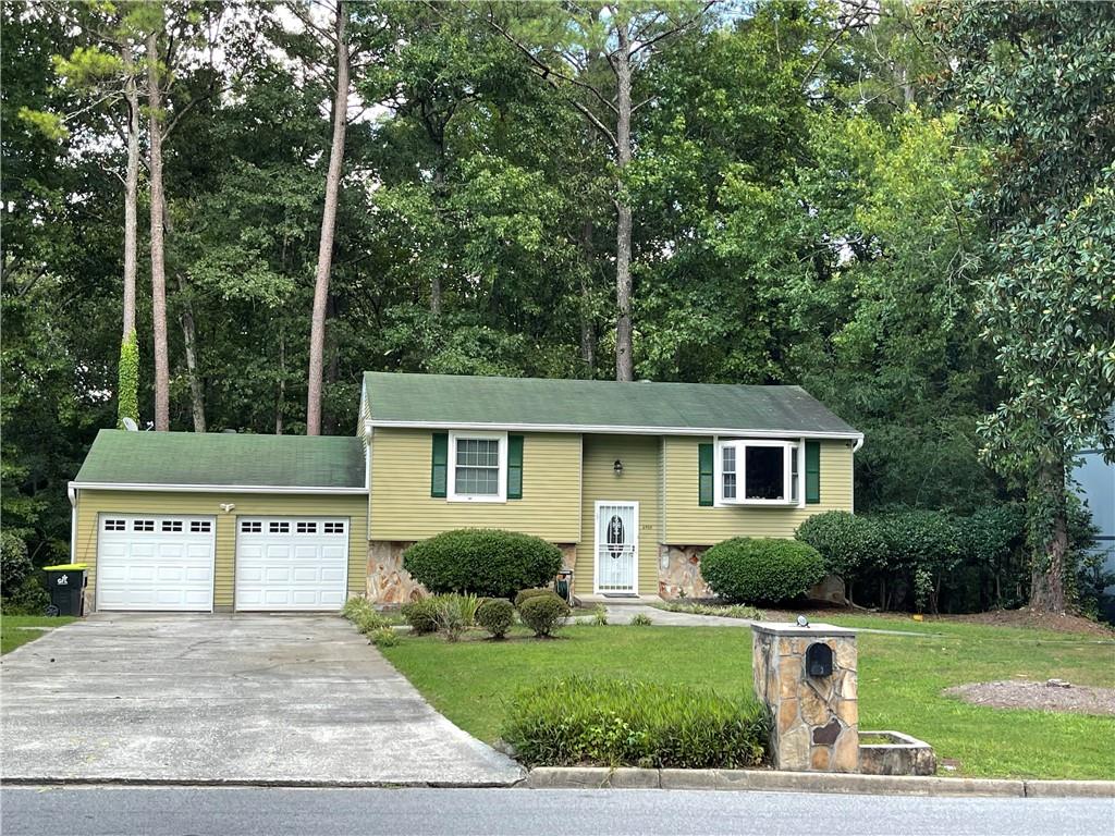 6400 Kimberly Mill Road Atlanta, GA 30349 - Photo 1 of 1 a view of a house with a yard and large trees