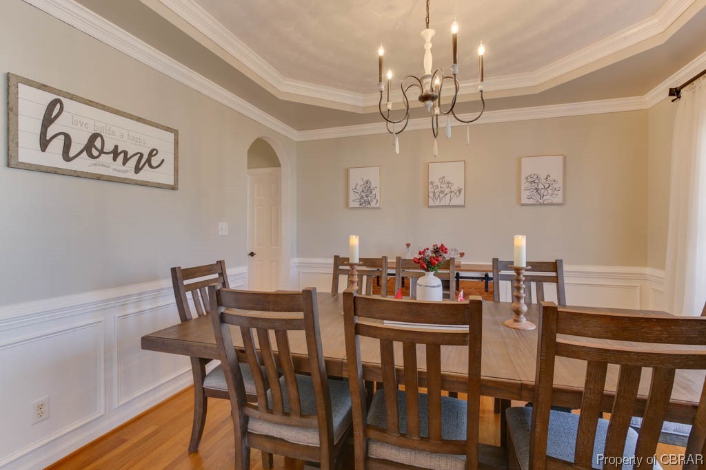 4 Willow Road Hampton, VA 23664 - Photo 10 of 48 Dining space featuring ornamental molding, light wood-type flooring, a chandelier, and a raised ceiling