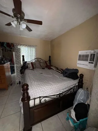 a bedroom with a bed a table and chair