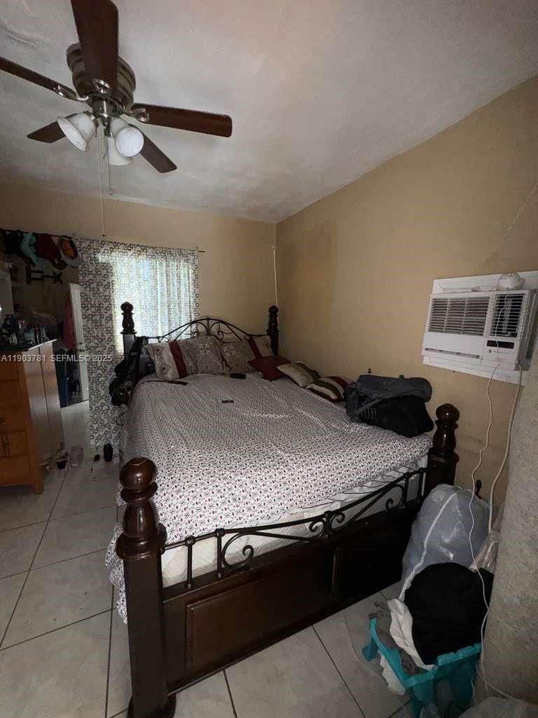 6391 Southwest 34th Street Miramar, FL 33023 - Photo 13 of 21 a bedroom with a bed a table and chair