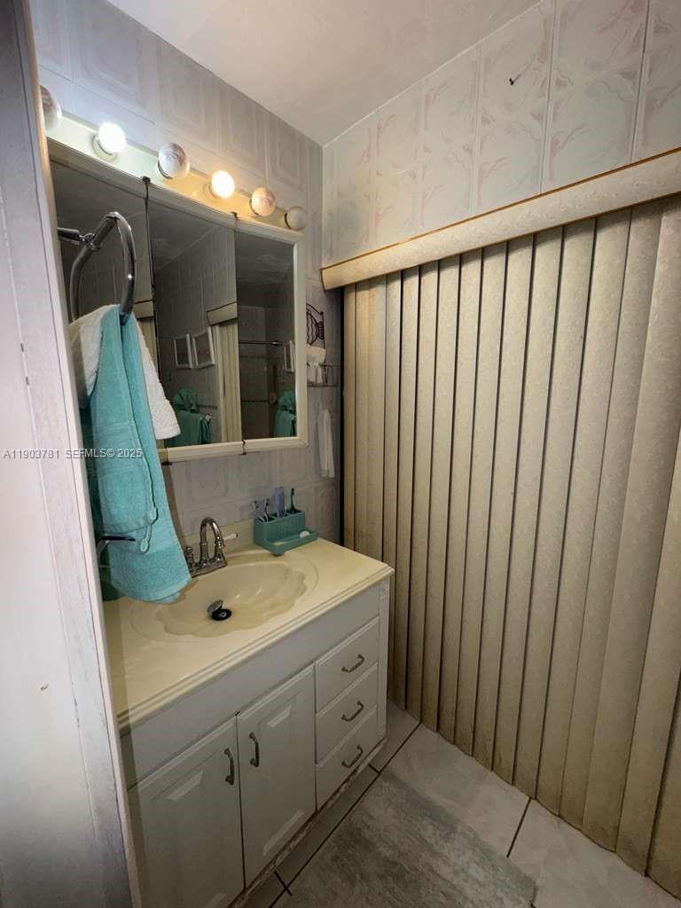 6391 Southwest 34th Street Miramar, FL 33023 - Photo 15 of 21 a bathroom with a sink and a mirror