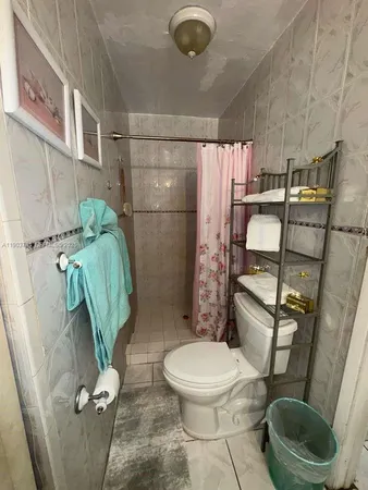 a bathroom with a toilet and a shower