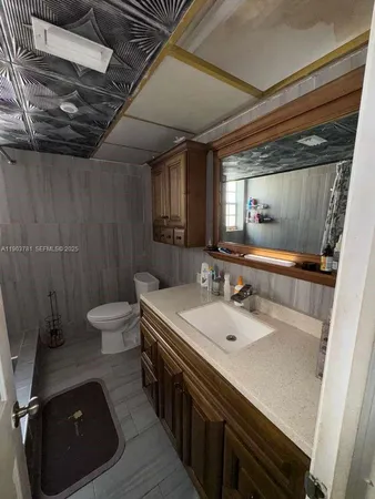 a bathroom with a double vanity sink toilet and a mirror