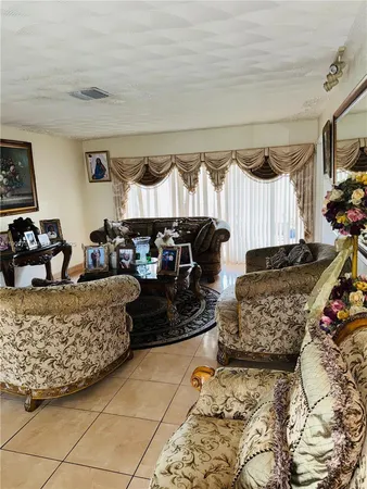 a living room with furniture a couch and a window