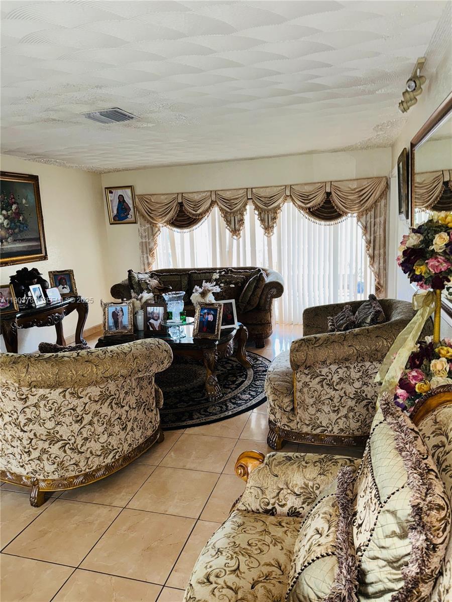 6391 Southwest 34th Street Miramar, FL 33023 - Photo 7 of 21 a living room with furniture a couch and a window
