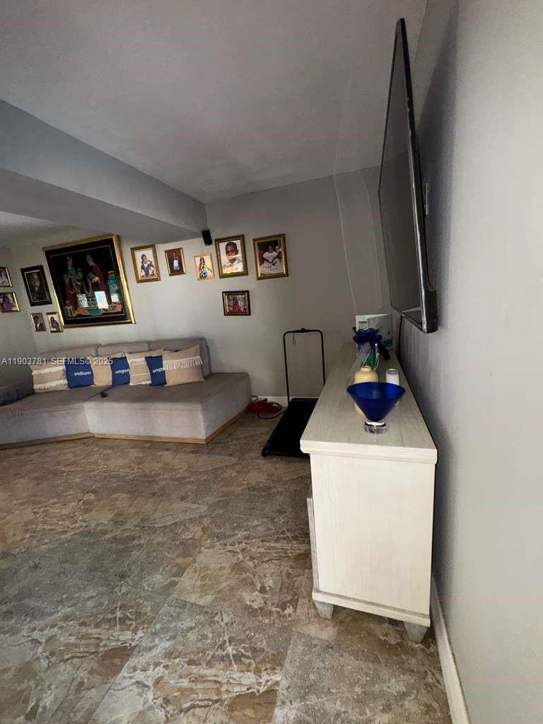 6391 Southwest 34th Street Miramar, FL 33023 - Photo 10 of 21 a living room with furniture and a flat screen tv