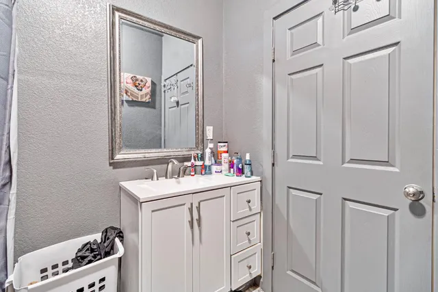 a bathroom with a sink a vanity and a mirror