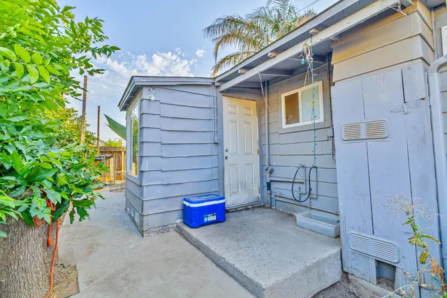 a view of a house with a small yard and a potted plant