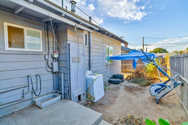 a view of a backyard with a table and chairs