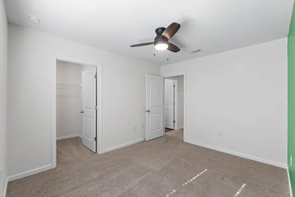 a view of a livingroom and a ceiling fan