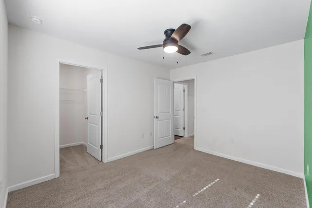 a view of a livingroom and a ceiling fan