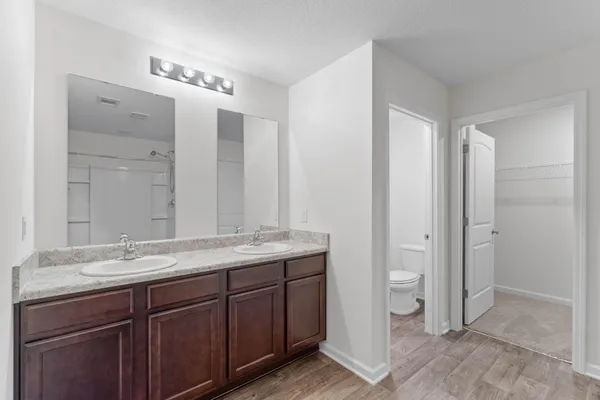 a bathroom with a granite countertop sink mirror and double