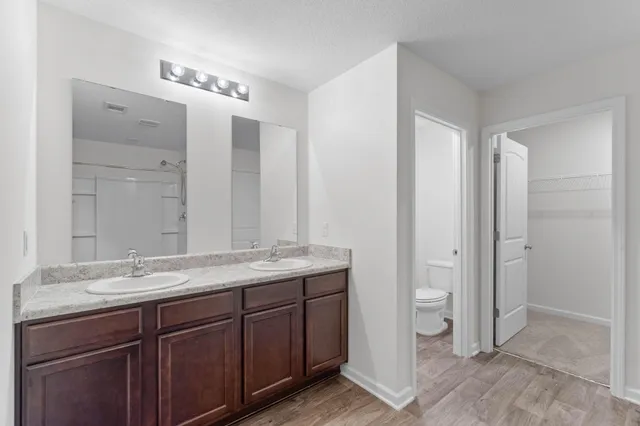 a bathroom with a granite countertop sink mirror and double