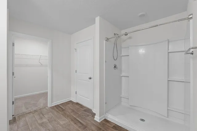 a bathroom with a shower and a glass door