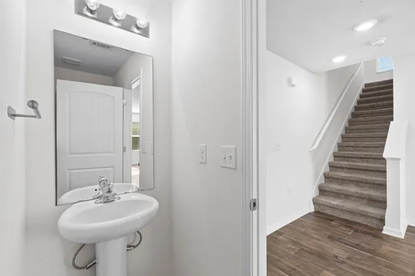 a bathroom with a sink a mirror and a toilet