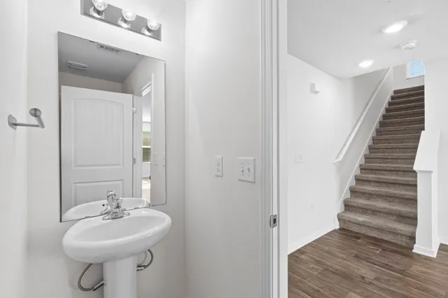 a bathroom with a sink a mirror and a toilet