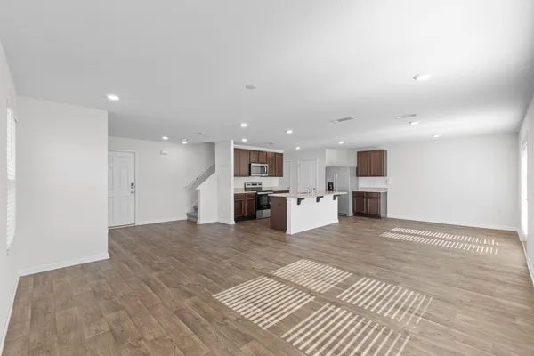 a view of kitchen with kitchen island sink and white cabinets