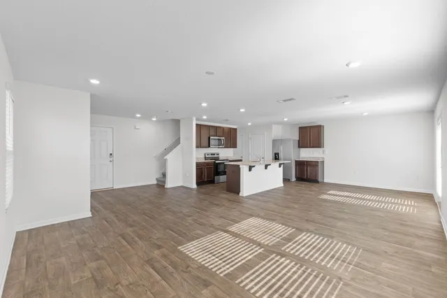 a view of kitchen with kitchen island sink and white cabinets