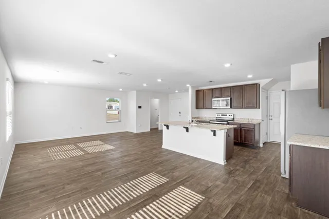 a large white kitchen with a white stove top oven and cabinets