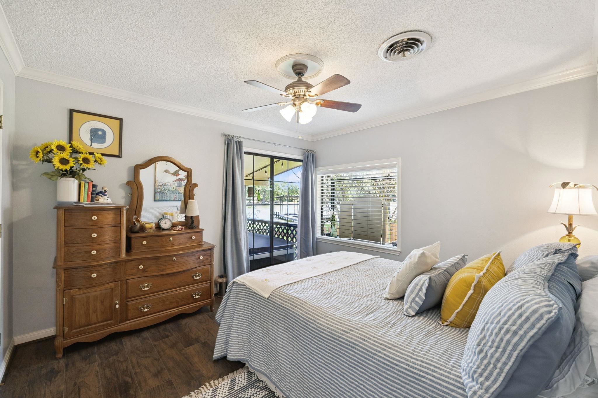 1435 East Zipp Road New Braunfels, TX 78130 - Photo 27 of 43 a bedroom with a bed and a chandelier