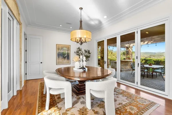 a view of a dining room with furniture wooden floor and chandelier