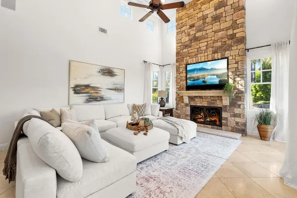 a living room with furniture a fireplace and a flat screen tv