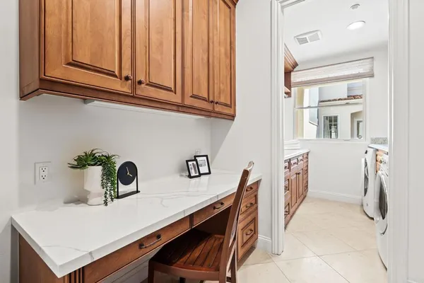 a kitchen with stainless steel appliances a sink a refrigerator and cabinets
