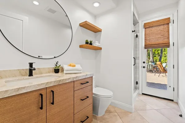 a bathroom with a sink a toilet and mirror